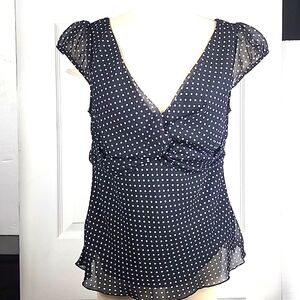 Polka-dot flirty top with sheer overlay. Size L